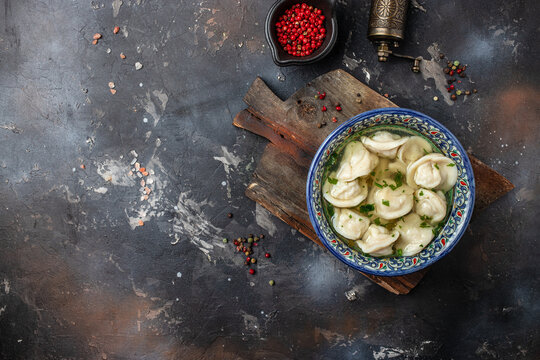 Dumplings in the soup chuchvara banner, menu, recipe place for text, top view. Uzbek cuisine