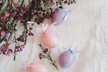 Easter eggs with flowers on white linen fabric. Spring and Easter concept.