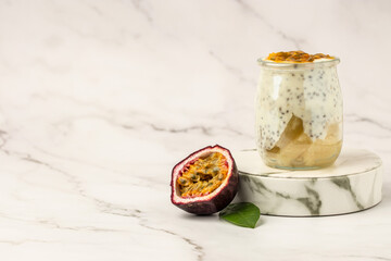 fresh passion fruit puree top on yogurt on a light background, Vegan healthy breakfast, clean eating. Long banner format. top view