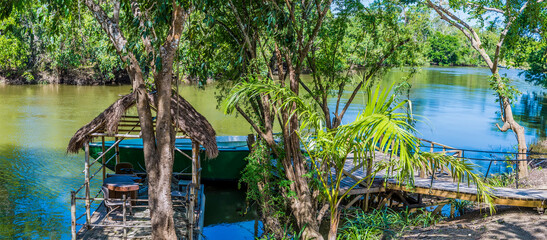 A panorama view from the banks of the Belize River in Belize on a sunny day