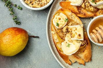 toasts croutons with cheese camembert and pear, honey, walnut, banner, menu, recipe place for text, top view