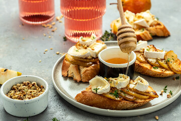 toasts croutons with cheese camembert and pear, honey, walnut, banner, menu, recipe place for text, top view - obrazy, fototapety, plakaty