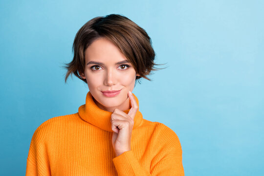 Portrait of pretty nice lady hand finger touch chin empty space isolated on blue color background