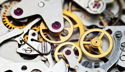 Cogwheels inside clockwork closeup