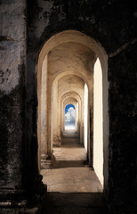 Heaven's gate. Dark tunnel corridor with arch opening to a beautiful cloudy sky. Light at the end of the tunnel.