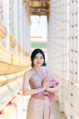 Beautiful Asian girl in Thai traditional costume at temple