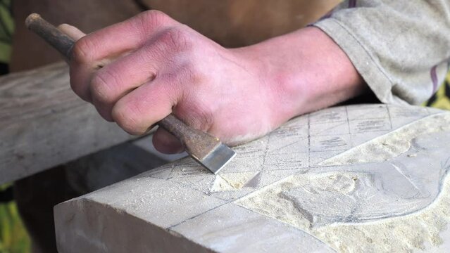 Closeup of skilled stonemason crafting a stone
