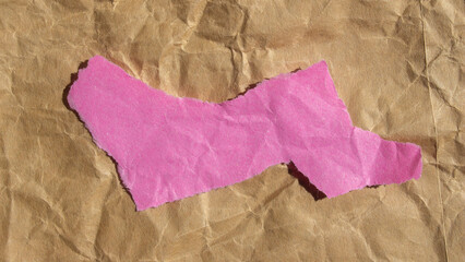 Crumpled pink paper background. Ripped paper piece with copy space.