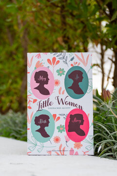 Close up Louisa May Alcott's Little Women Novel in The Garden. 