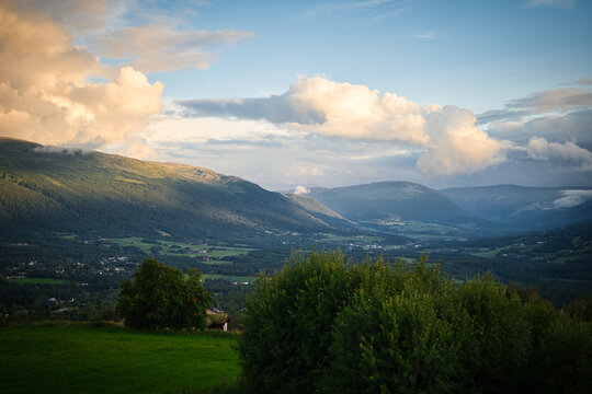 Fototapeta Cloudy bright sky over the rural hills of Oppdal, Norway