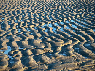 Snow on low tide sand