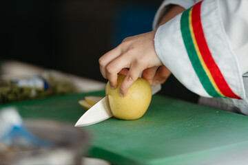Close up hand slicing apple