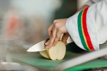 Close up hand slicing apple