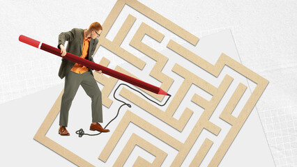Working on way to professional success. Young man, employee drawing lines on labyrinth to reach...