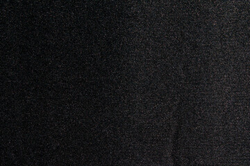 Black paper fabric texture background. Dark blank surface for designs.