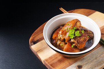 Food concept Spot focus Homemade Asian 5 spice  braised pork on black background with copy space