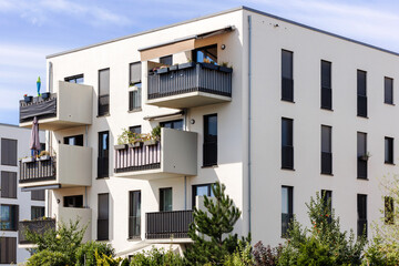 Fototapeta na wymiar Modern Exterior House with Comfort Balcony, Patio Garden and Landscaping. Modern Design of Apartment Building in Germany, Europe.