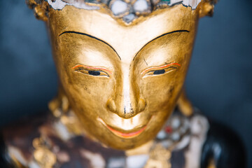 A statue of a buddha with a gold face 