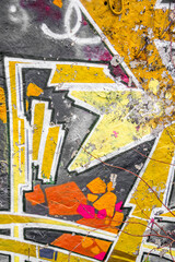 Abstract multicolored graffiti drawings. Wall painting yellow and grey. Cement background with...