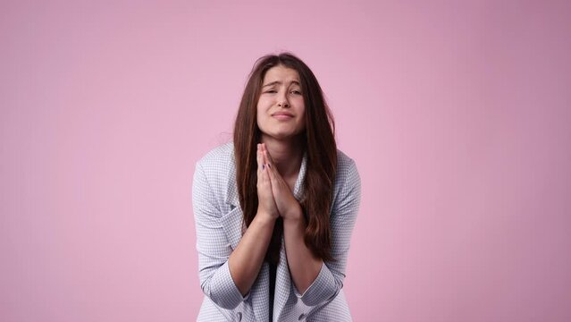 4k video of one girl who pleading over pink background.