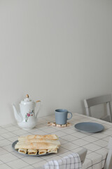 Stack of crepes on kitchen table. Pancakes for breakfast, food photography