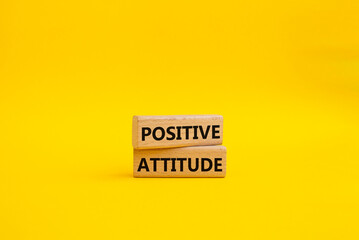 Positive attitude symbol. Concept words Positive attitude on wooden blocks. Beautiful yellow background. Business and Positive attitude concept. Copy space.