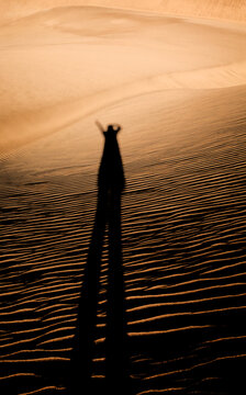 Hiker in the dunes of Maspalomas, Gran Canaria, Canary Islands, Spain.