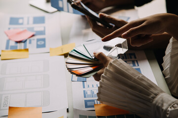 Close up ux developer and ui designer use augmented reality brainstorming about mobile app...