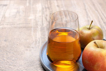 a glass of apple juice, a copy of the space