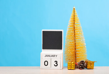 Merry Christmas and happy new year. White block calendar with date january 03 and Christmas decor...