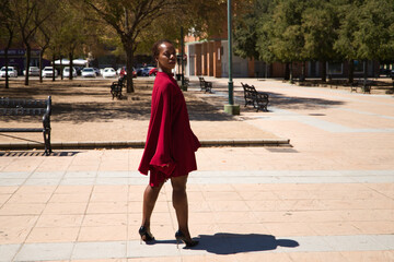 Young and beautiful Afro American woman posing in different poses while visiting the city on her business trip.