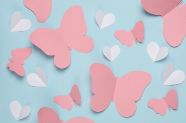 Butterflies and hearts cut out of paper on blue background. Spring background, love concept....