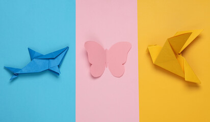 Origami shark, butterfly and dove on a colored background. Varieties of classes animals. Insects,...