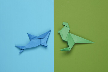 Origami shark and dinosaur on paper background