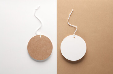 Empty round craft and white paper price tags with string. Template for design