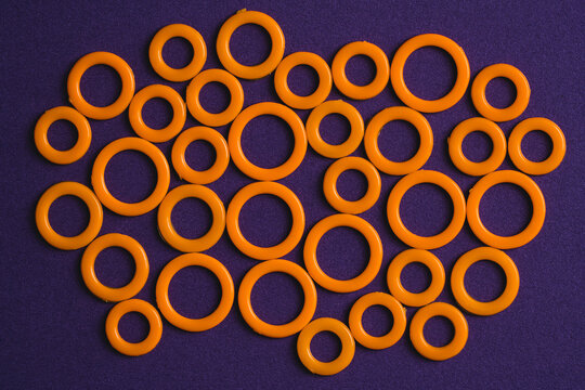 Colorful plastic rings on purple surface