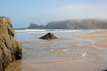 Sea and Rocks With Mist at Odeceixe Beach; Algarve; Portugal