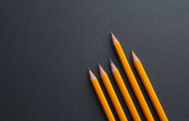 Yellow pencils on a dark background. Creativity set