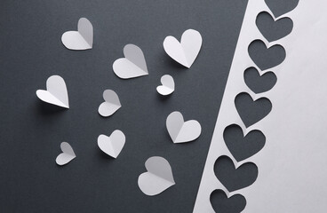 Paper-cut hearts and a stencil shape on a gray background. Valentine's day, love, creative layout