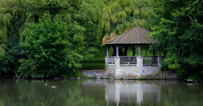 Beautiful closeup of a gazebo by duck pond at Virginia tech university surrounded by dense trees