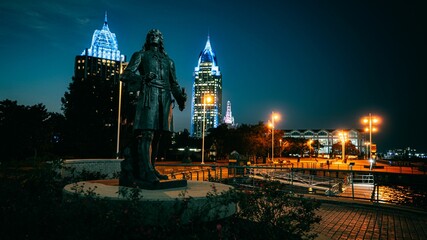 The Pierre d'Iberville Statue with skylines in Mobile, Alabama