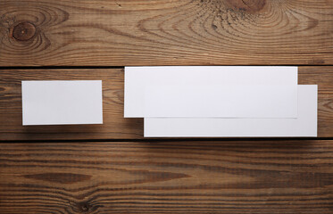 Mockup of two white blank tickets or flyers and business card on wooden background. Template for design