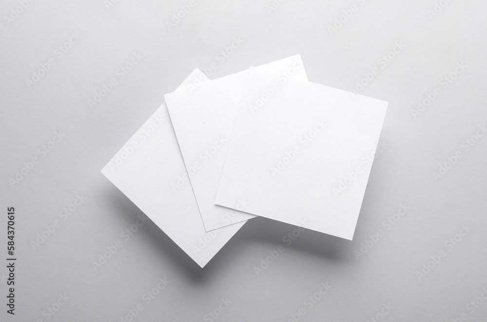 Poster white empty square memo pieces of paper on gray background. template for design. top view
