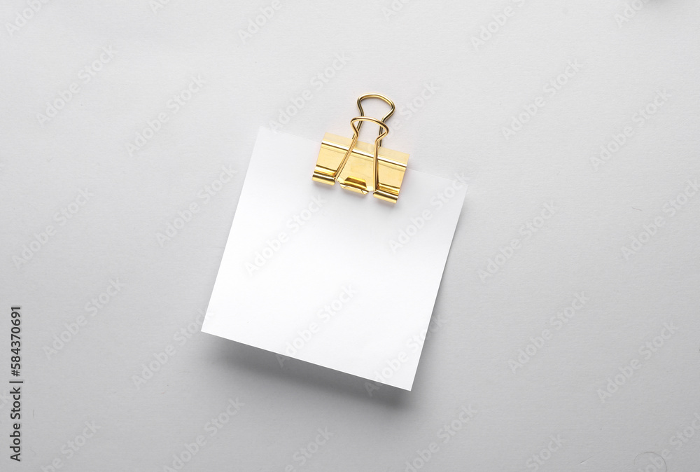 Poster white empty square memo sheet of paper with binder on gray background. template for design.