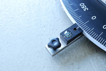 Compass at zero. Close-up of zero-degree north compass on telescope arm for use in angular or...