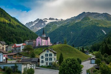 Fototapeta na wymiar The Trient Eglise Rose church in the Swiss Alps with a green landscape