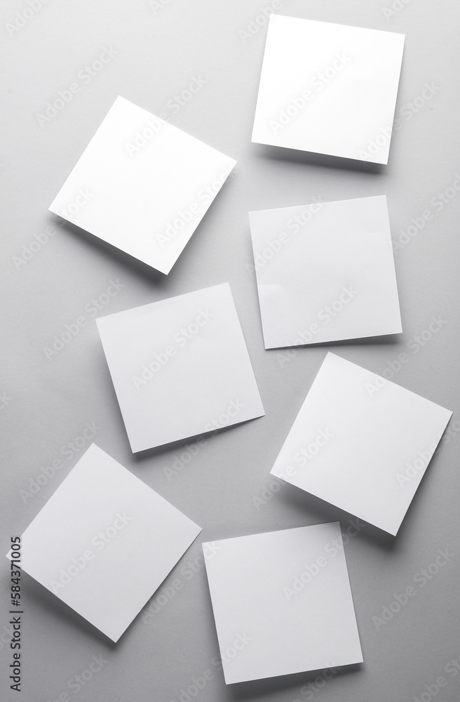 Poster white empty square memo sheets of paper on gray background. template for design.