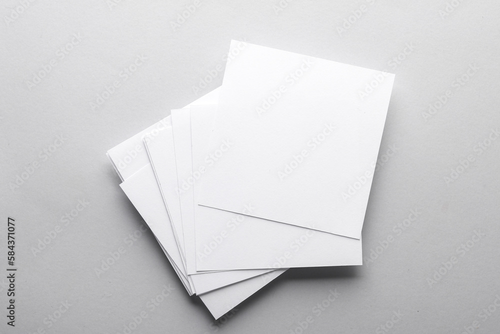 Poster white empty square memo sheets of paper on gray background. template for design.