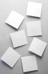 White empty square memo sheets of paper on gray background. Template for design.