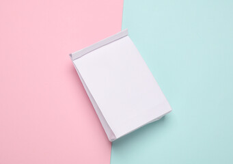 White paper lunch bag mockup on pink blue background. Template for design. Top view